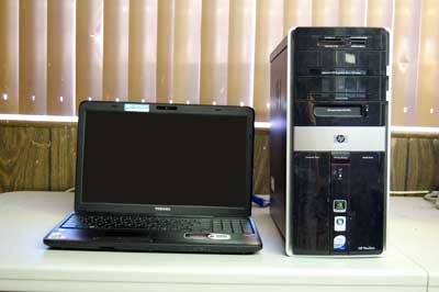 A laptop and desktop computer ready for recycling