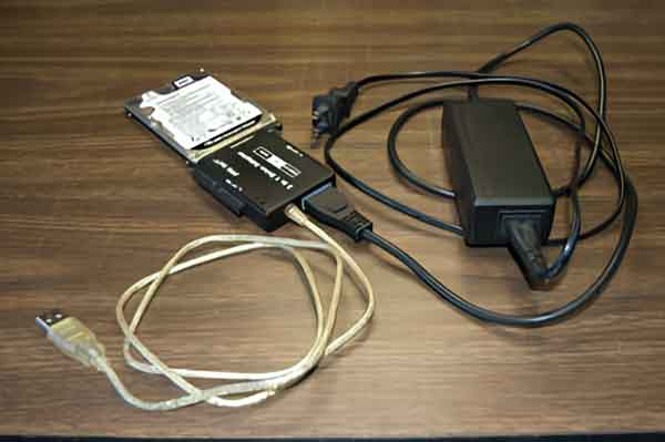 A laptop hard drive connected to a USB adapter