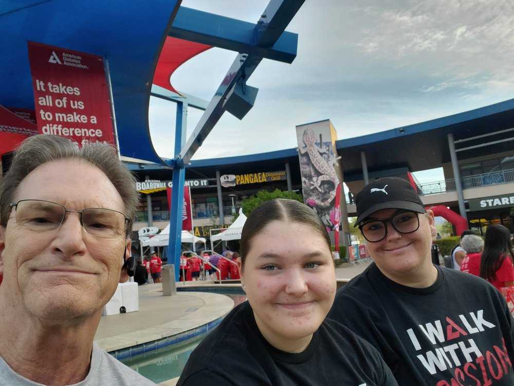 Geeks in Phoenix participate in the American Diabetes Association's Step Out Walk Three members of the St. Gelais family smiling in front of an American Diabetes Association banner at the Step Out Walk